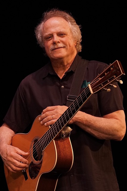 Pat Donohue holding his guitar